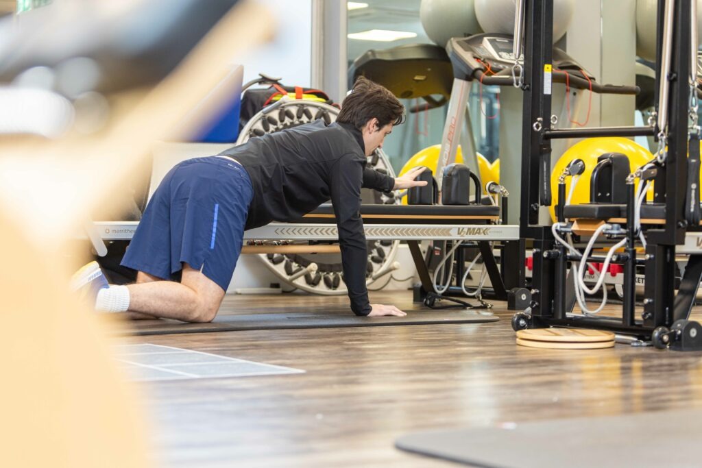 Men's Health Physio 1 Male patient conducting Pilates exercise
